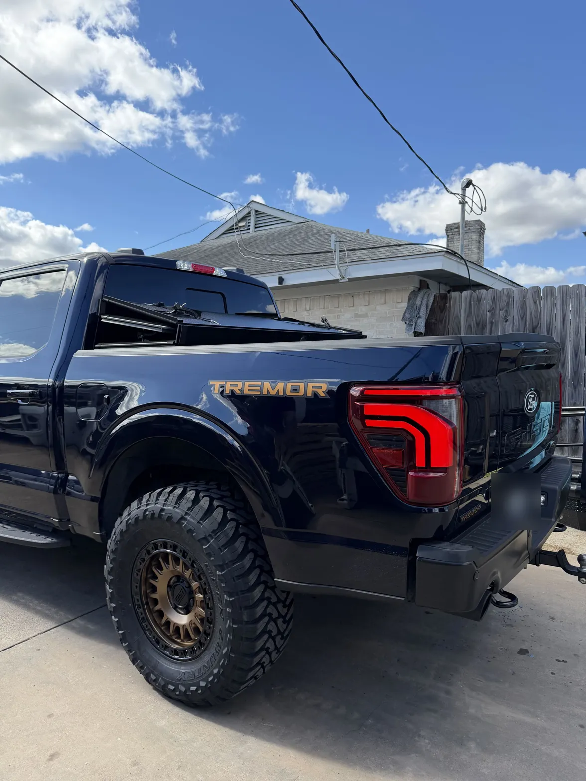 2025 Ford F-150 Tremor on 18x9 KMC KM552 IMS wheels in Matte Bronze with Gloss Black Lip and 35x12.50R18 Toyo Open Country M/T tires